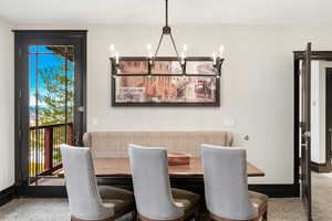 Dining area featuring a chandelier and baseboards