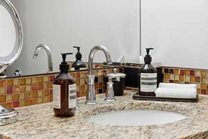 Bathroom view of decorative backsplash and vanity