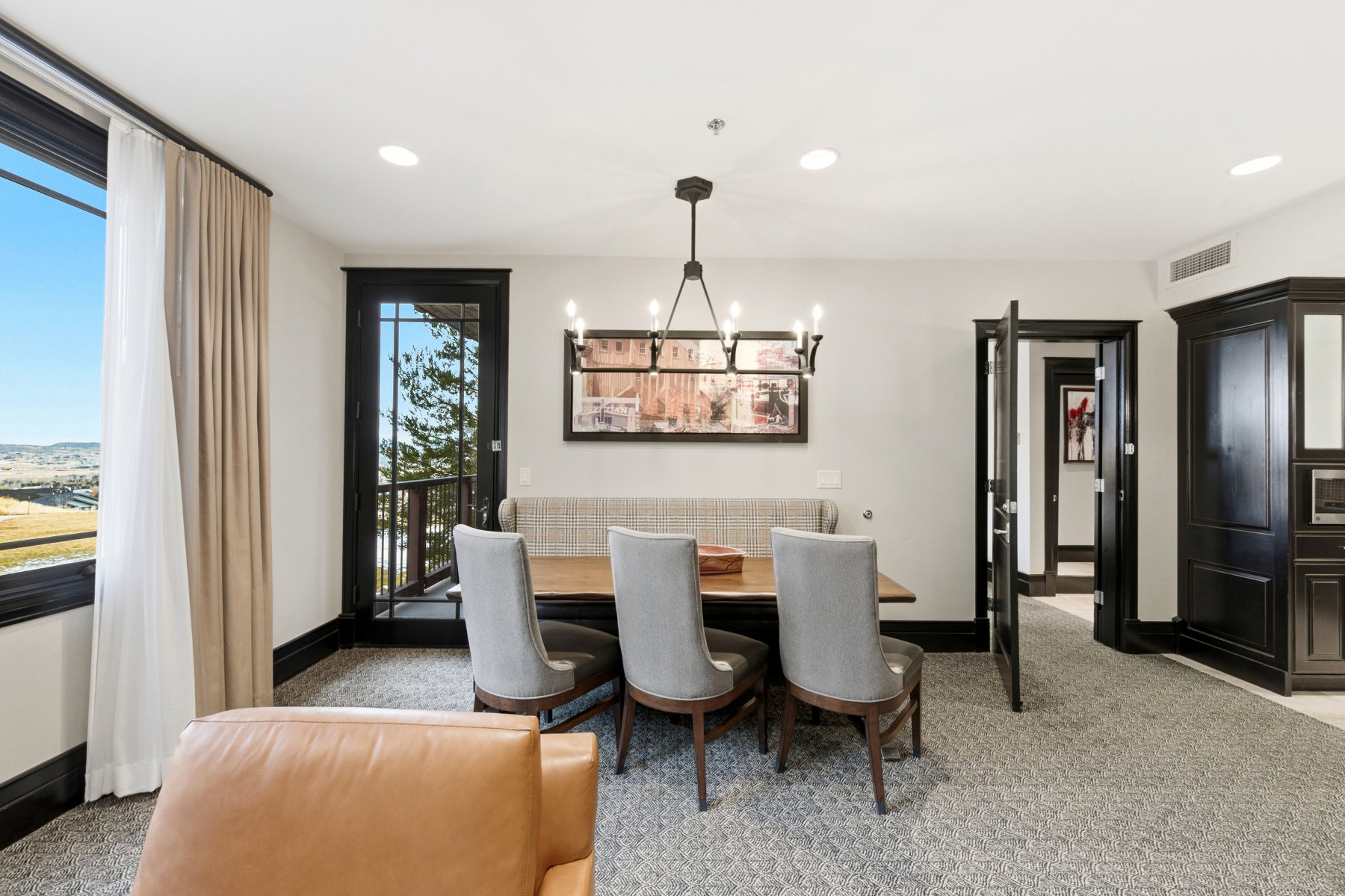 Dining room with a chandelier and recessed lighting