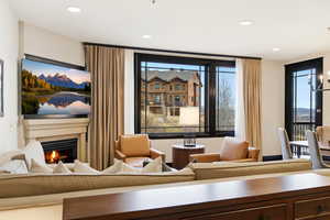 Living area featuring a warm lit fireplace and recessed lighting