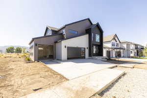 View of front of home featuring driveway, a garage, and a residential view