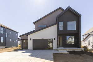 Contemporary home featuring driveway and a garage