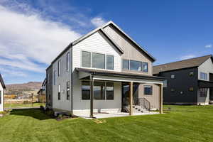 Back of house featuring a yard and a patio