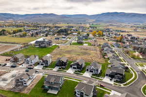 Aerial view of property's location with nearby suburban area and a mountainous background