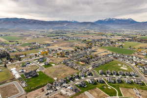 Aerial view of property's location with a mountainous background and nearby suburban area