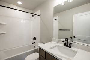 Bathroom with shower / tub combination, vanity, and recessed lighting
