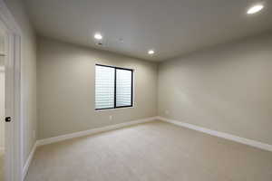 Unfurnished room featuring light carpet and recessed lighting
