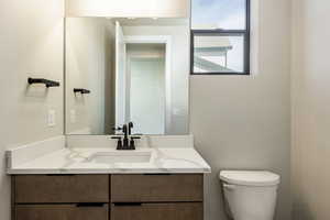 Bathroom featuring vanity and toilet