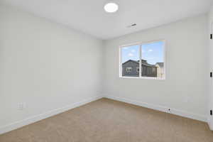 Spare room with baseboards and carpet floors