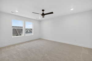 Empty room with light colored carpet, recessed lighting, and ceiling fan