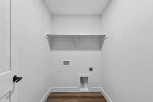 Laundry room with hookup for an electric dryer, dark wood finished floors, and hookup for a washing machine