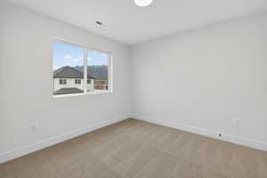 Unfurnished room with carpet flooring and baseboards