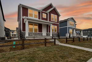 Craftsman-style house featuring covered porch and board and batten siding