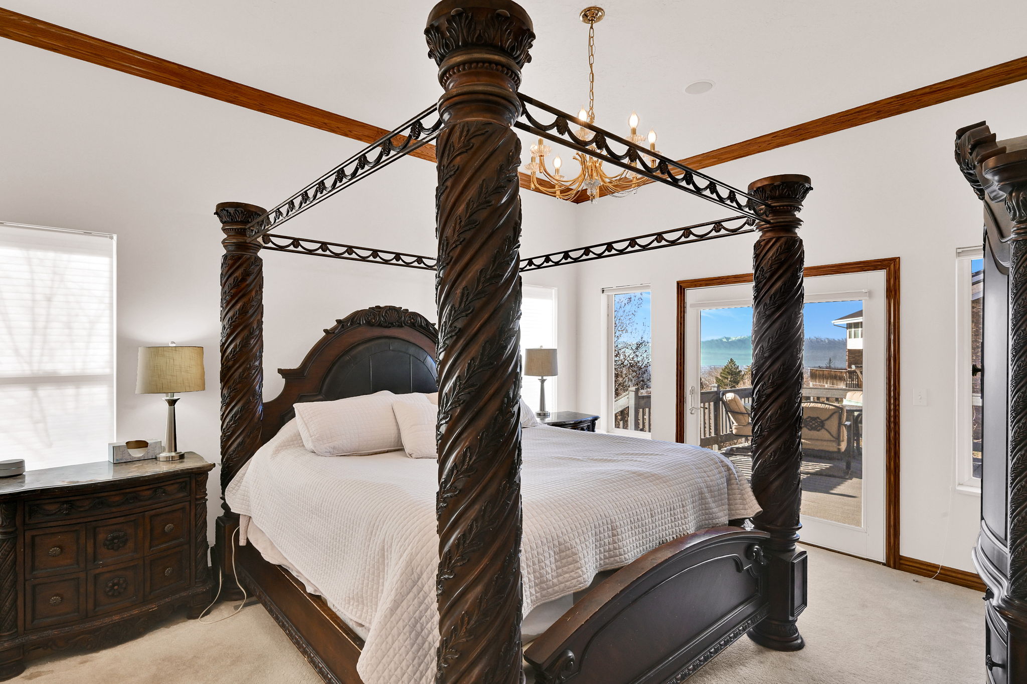 Bedroom with light carpet, access to outside, and crown molding