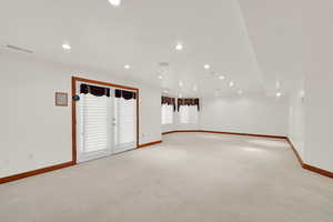 Unfurnished room with light carpet and recessed lighting