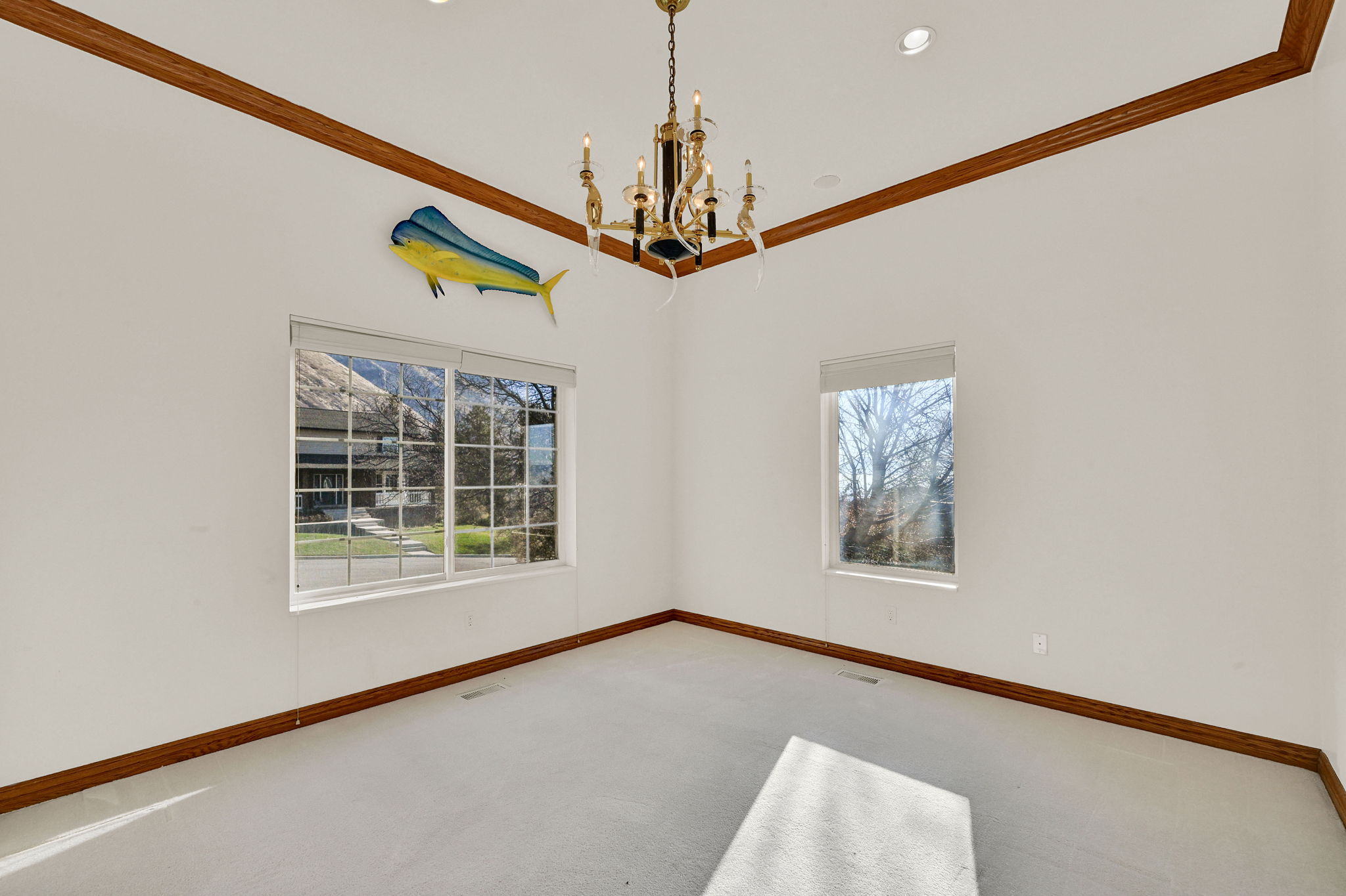 Unfurnished room with ornamental molding, a chandelier, carpet, plenty of natural light, and recessed lighting