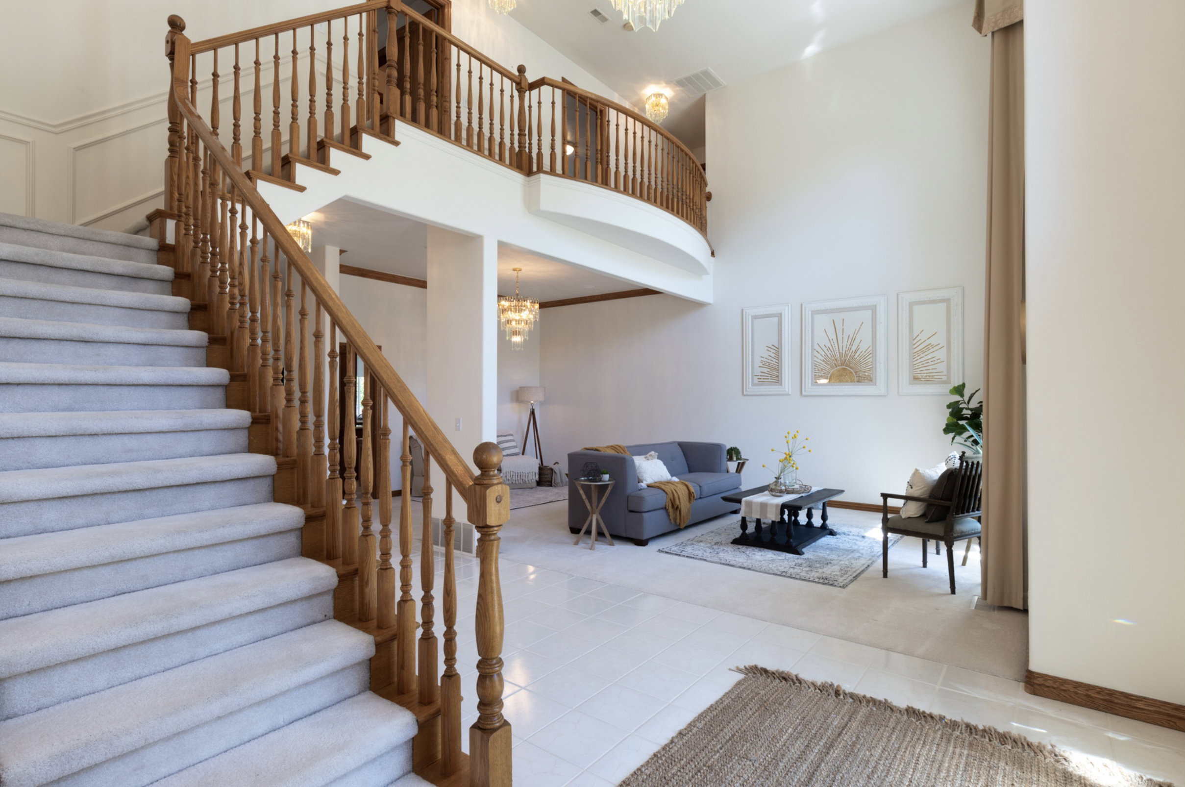 Stairs with a chandelier, a towering ceiling, and tile patterned floors