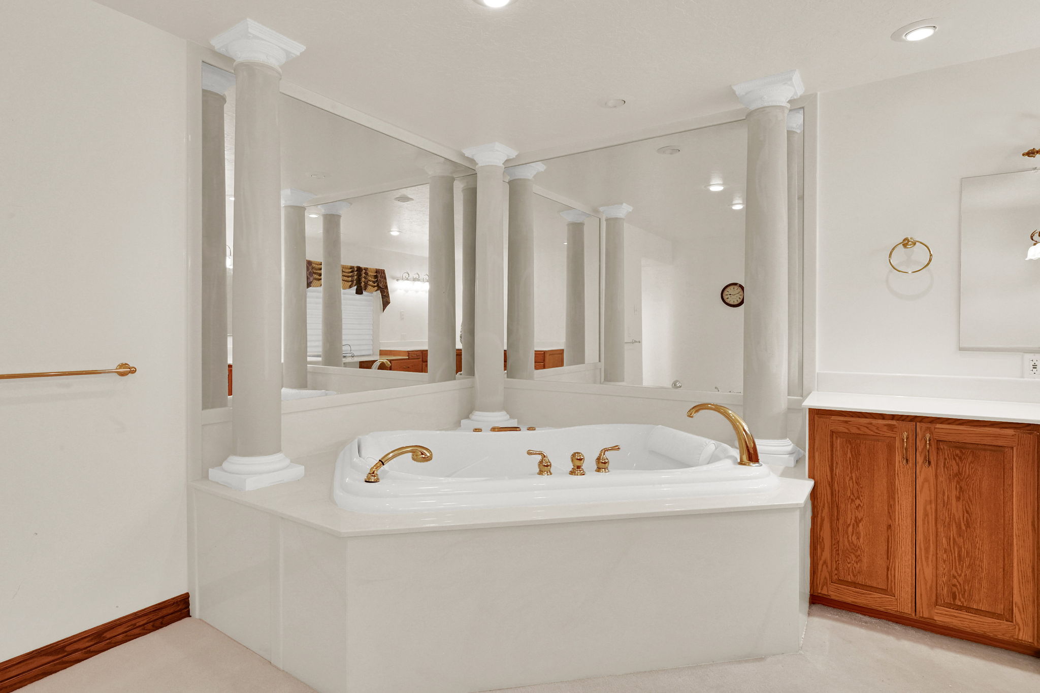 Full bathroom featuring a garden tub and vanity