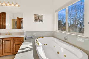 Bathroom featuring a whirlpool tub and vanity
