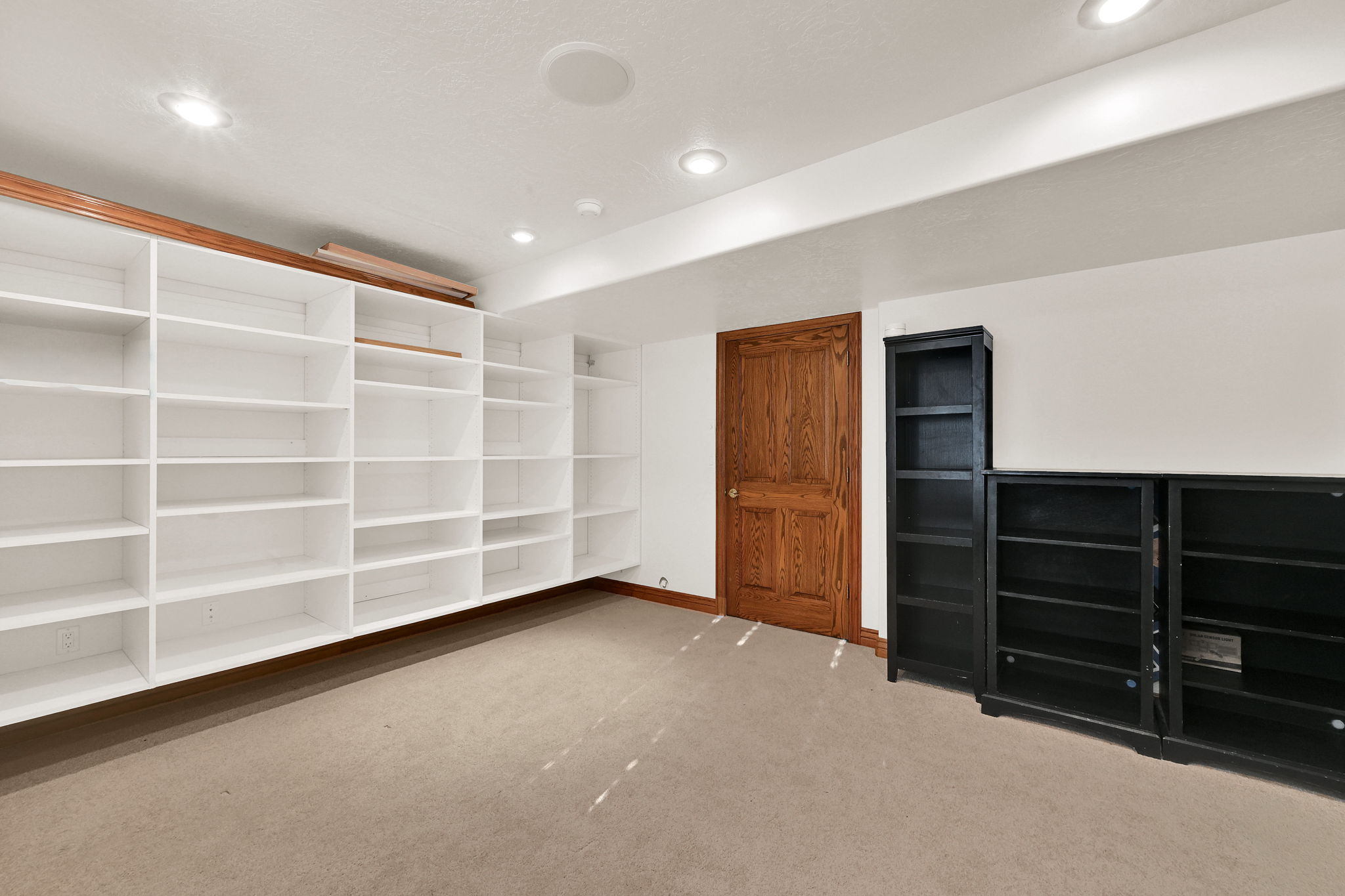 Interior space with recessed lighting and light carpet
