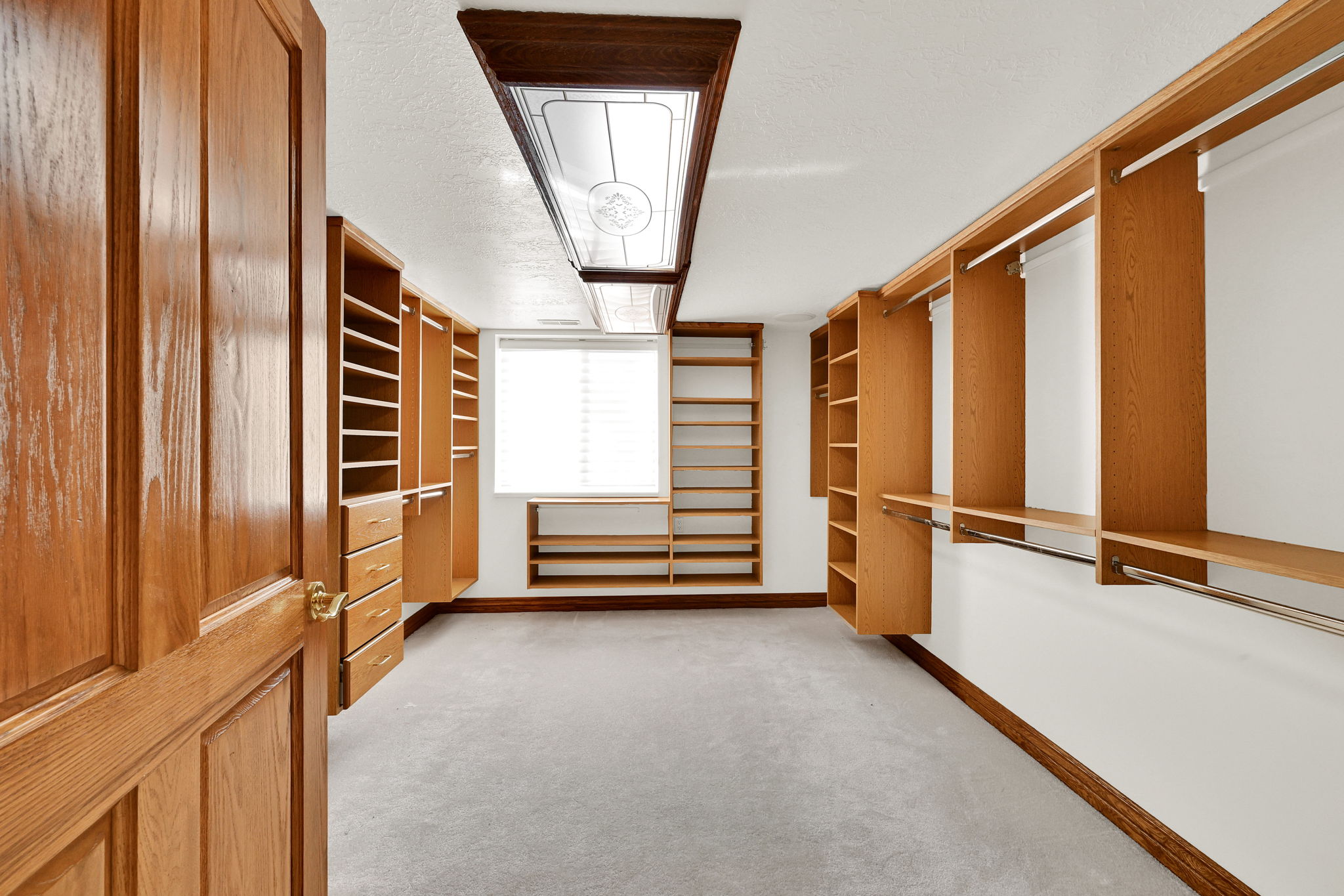 Walk in closet featuring light carpet
