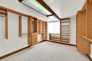 Walk in closet featuring light carpet