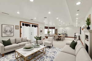 Carpeted living room with recessed lighting and a fireplace