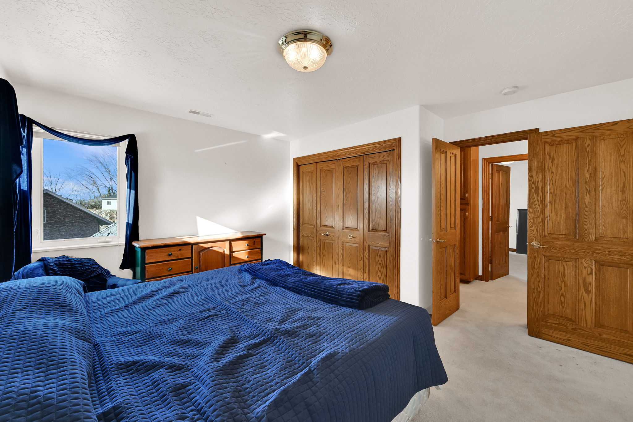 Bedroom featuring light colored carpet and a closet