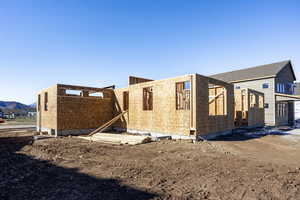 View of side of home with a mountain view