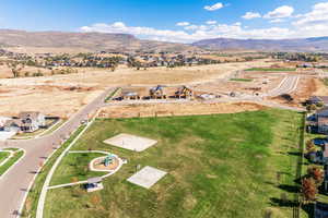 Aerial view of property and surrounding area featuring mountains