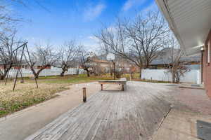 Wooden deck featuring a residential view and basketball court