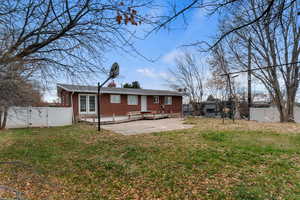 Rear view of property featuring a gate, a patio, a fenced backyard, french doors, and brick siding