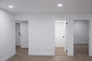Unfurnished bedroom with light wood-style floors and recessed lighting