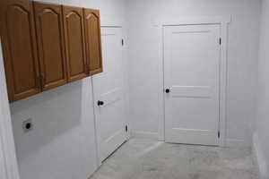 Washroom featuring cabinet space and hookup for an electric dryer