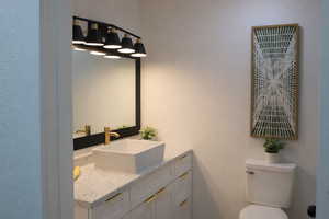 Bathroom featuring a textured wall and vanity