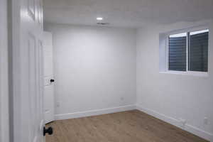Unfurnished room featuring wood finished floors and baseboards