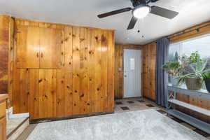 Foyer entrance with wood walls