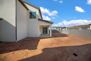 Fenced backyard featuring a patio and a residential view