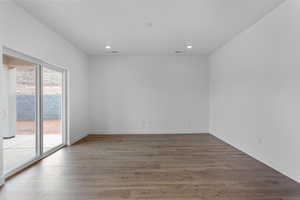 Spare room with wood finished floors and recessed lighting