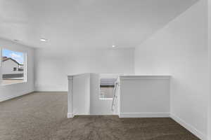 Carpeted empty room featuring recessed lighting