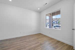 Unfurnished room with light wood finished floors and recessed lighting