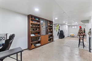 Basement featuring a textured ceiling and recessed lighting