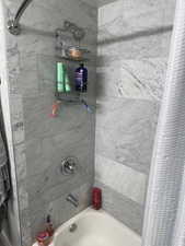 Bathroom with shower / tub combo with curtain