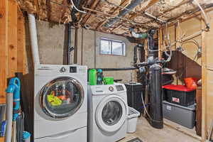 Laundry area featuring concrete floors and washer and dryer