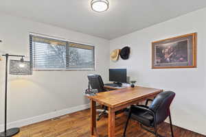Office area featuring baseboards and light wood finished floors