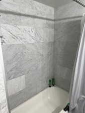 Bathroom featuring shower / bath combo with shower curtain