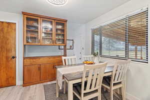 Dining room with light wood-style floors and baseboards