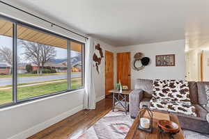 Living area with wood finished floors and baseboards