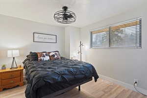 Bedroom with light wood-style flooring and baseboards