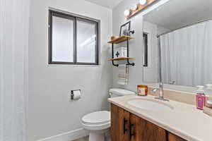 Bathroom featuring a shower with curtain and vanity